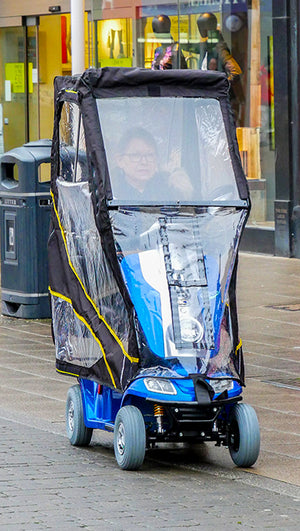woman using Scooterpac Universal Foldaway mobility scooter Canopy. automated Rain protection