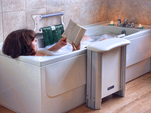 Woman using the Molly Bather Bath Lift, Slim Belt Bath Aid. British Made. Bath Hoist for Elderly and Disabled