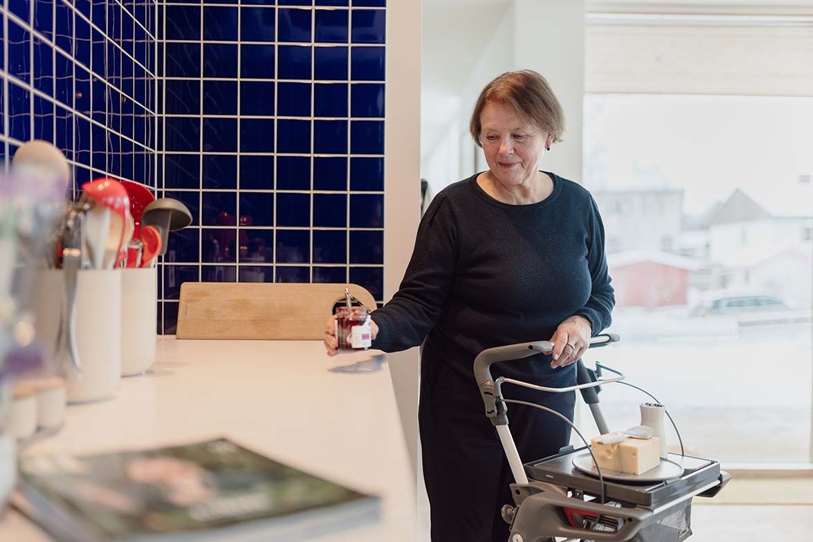 Woman using ToPro Hestia Rollator with food on the tray